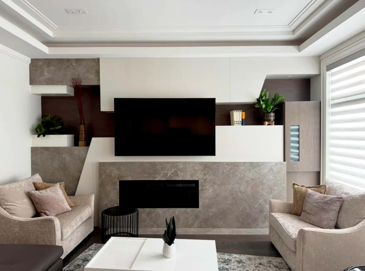 Family room with a stone-clad fireplace wall, television and stepped white and walnut joinery